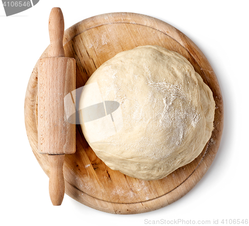 Image of fresh raw dough on wooden board