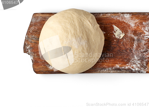 Image of fresh raw dough on wooden board