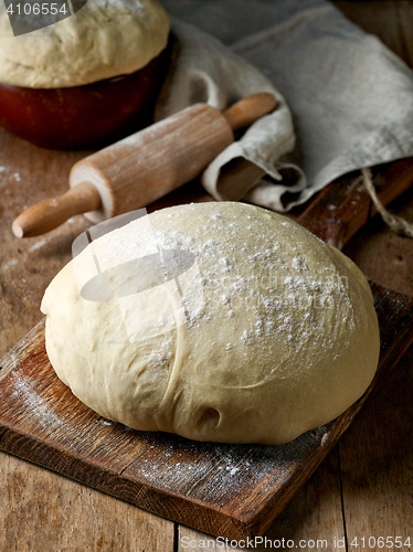 Image of fresh raw dough on wooden table