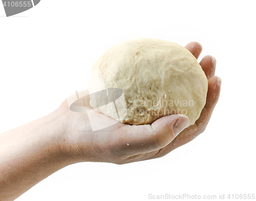 Image of fresh dough ball in human hand