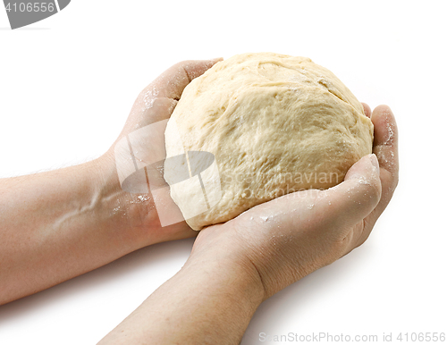 Image of fresh raw dough in bakers hands