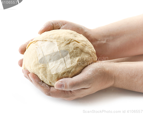 Image of fresh raw dough in bakers hands