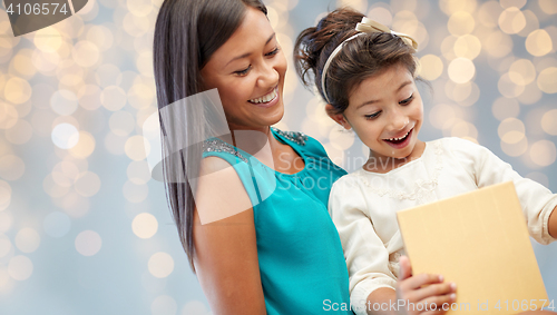 Image of happy mother and child girl with gift box