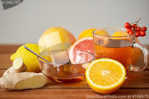 Image of tea with honey, lemon and ginger on wood