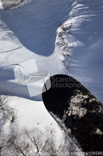 Image of View from chair-lift on snowboard over off-piste slope