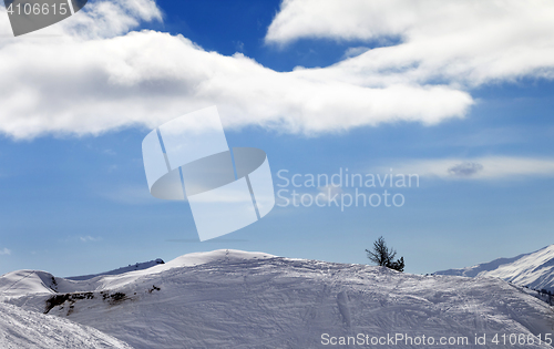 Image of Off-piste slope with traces from skis and snowboard in sun day