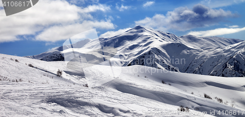 Image of Off-piste slope and beautiful sky with clouds in sun evening