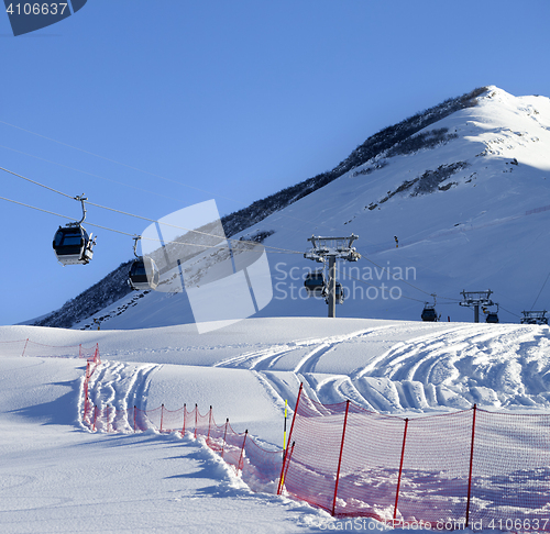 Image of Gondola lift on ski resort at sun winter day