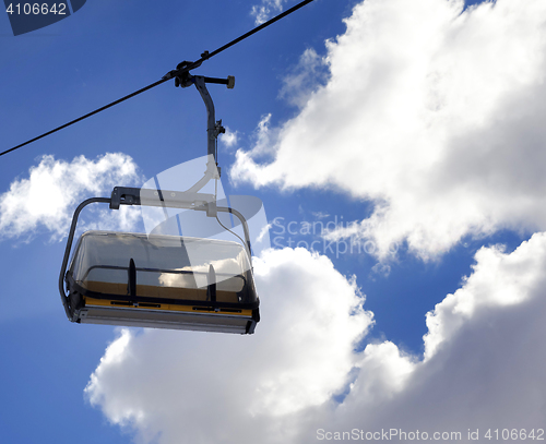 Image of Chair-lift and sunlight sky