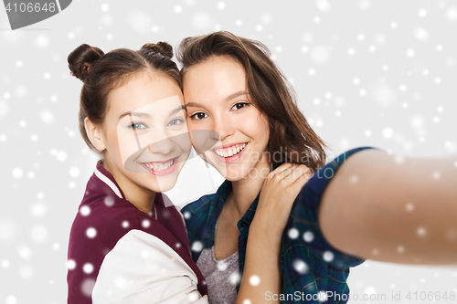 Image of happy smiling pretty teenage girls taking selfie