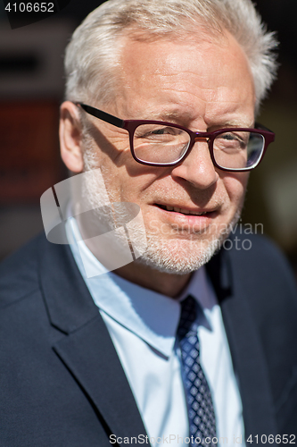 Image of close up of senior businessman in eyeglasses