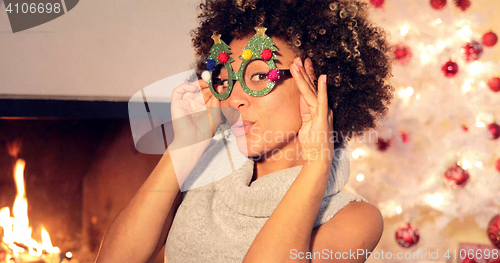 Image of Fun vivacious young woman celebrating Christmas