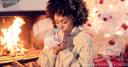 Image of Young woman drinking spicy lemon tea