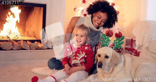Image of Family Christmas celebration next to fireplace