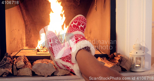 Image of Young woman relaxing in Christmas booties