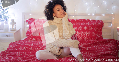 Image of Young woman celebrating alone at Christmas