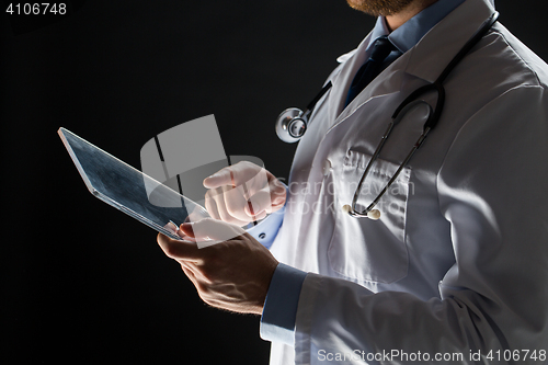 Image of close up of doctor with tablet pc and stethoscope