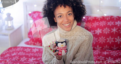 Image of Happy young woman relaxing at Christmas