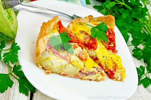 Image of Flan with tomato and zucchini in plate on board