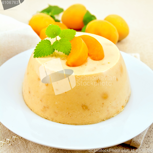 Image of Panna cotta apricot with fruit and mint on table