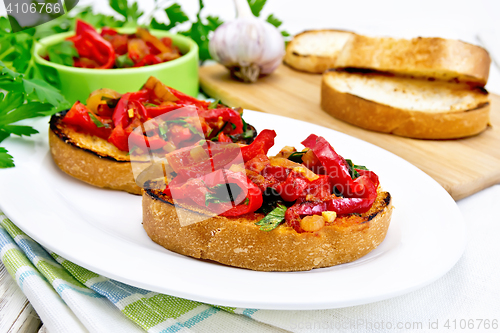 Image of Bruschetta with vegetables in plate on light board