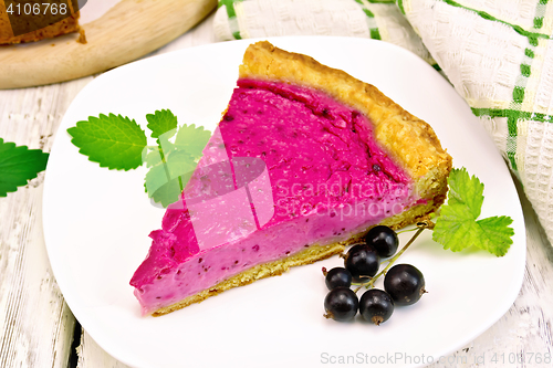 Image of Pie of black currants in plate on light board