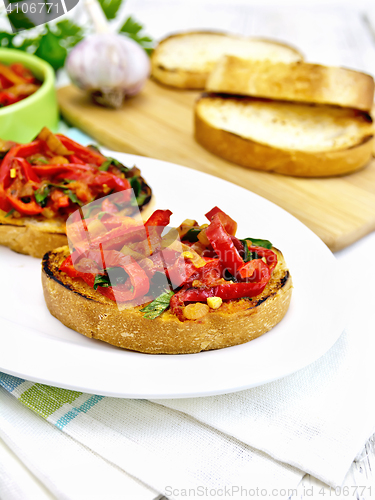 Image of Bruschetta with tomatoes and peppers in plate on napkin