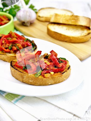 Image of Bruschetta with tomatoes and peppers in plate on napkin