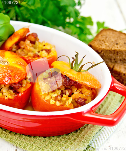 Image of Tomatoes stuffed with bulgur in pan on napkin