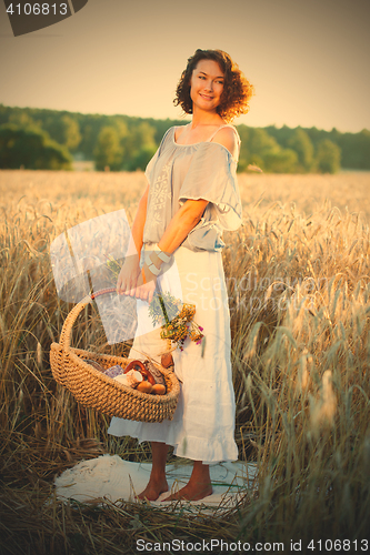 Image of beautiful woman in trendy summer dress in field