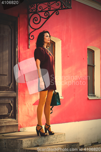 Image of beautiful white woman in a burgundy dress