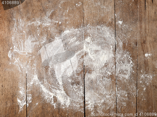 Image of white flour on wooden table