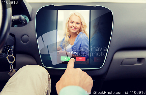 Image of close up of man using phone application in car