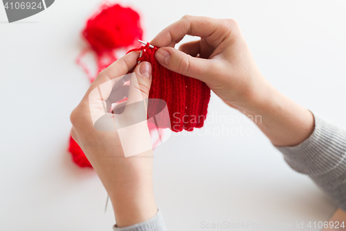 Image of woman hands knitting with needles and yarn