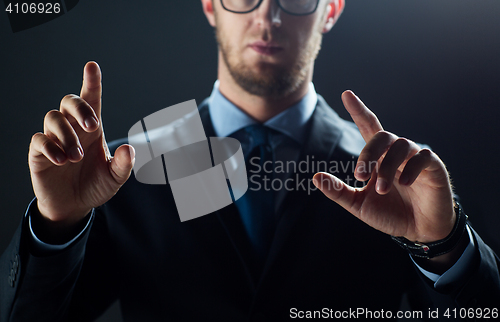 Image of close up of businessman touching virtual screen