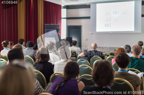 Image of Audience in lecture hall participating at business conference.