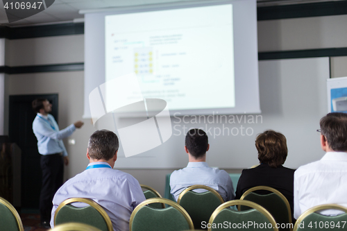 Image of Audience in lecture hall participating at business conference.