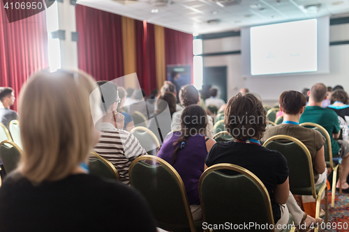 Image of Audience in lecture hall participating at business conference.