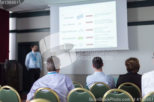 Image of Audience in lecture hall participating at business conference.