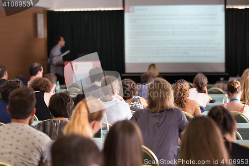 Image of Audience in lecture hall participating at business conference.