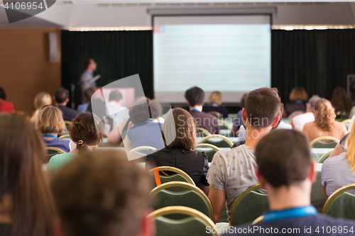 Image of Audience in lecture hall participating at business conference.