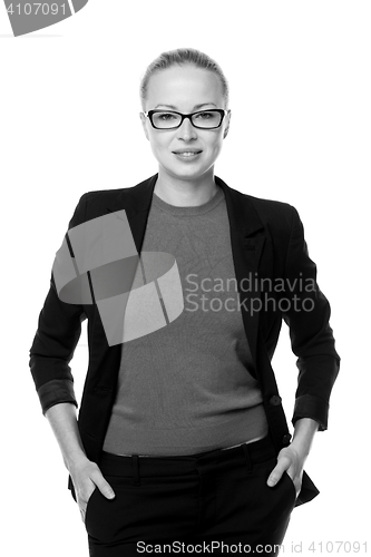 Image of Business woman standing arms in pockets against white background..