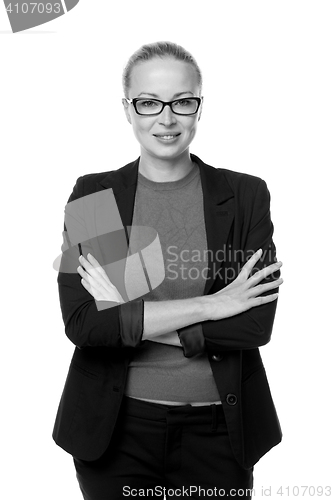 Image of Business woman standing with arms crossed against white background..