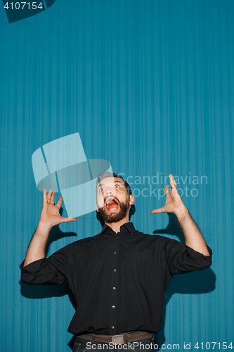 Image of Portrait of young man with shocked facial expression