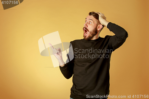 Image of Portrait of young man with shocked facial expression