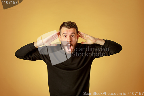 Image of Portrait of young man with shocked facial expression