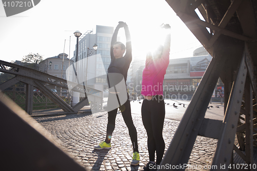 Image of couple warming up before jogging