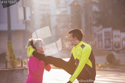 Image of couple warming up before jogging