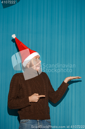 Image of Surprised christmas man wearing a santa hat