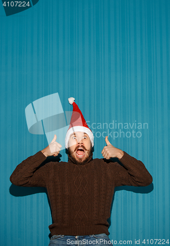 Image of Smiling christmas man wearing a santa hat